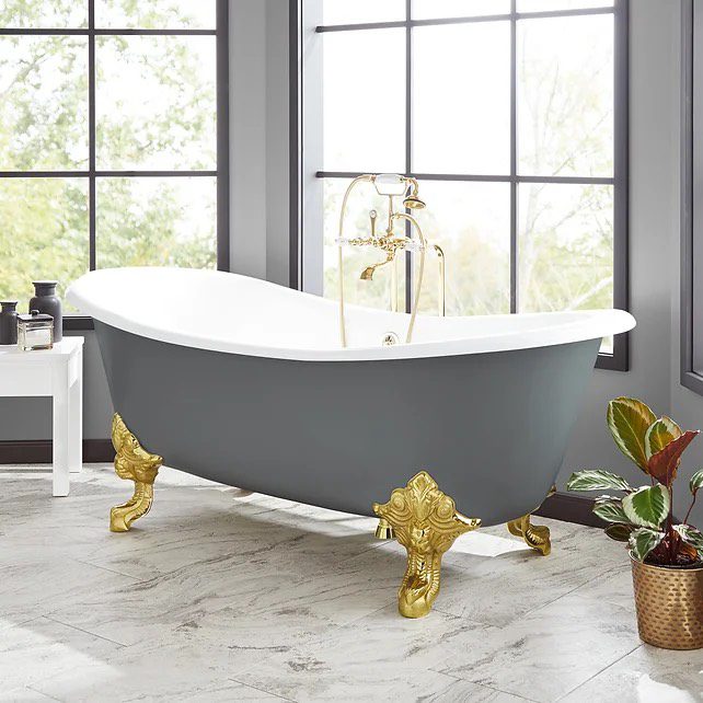 Grey clawfoot bathtub with gold feet.