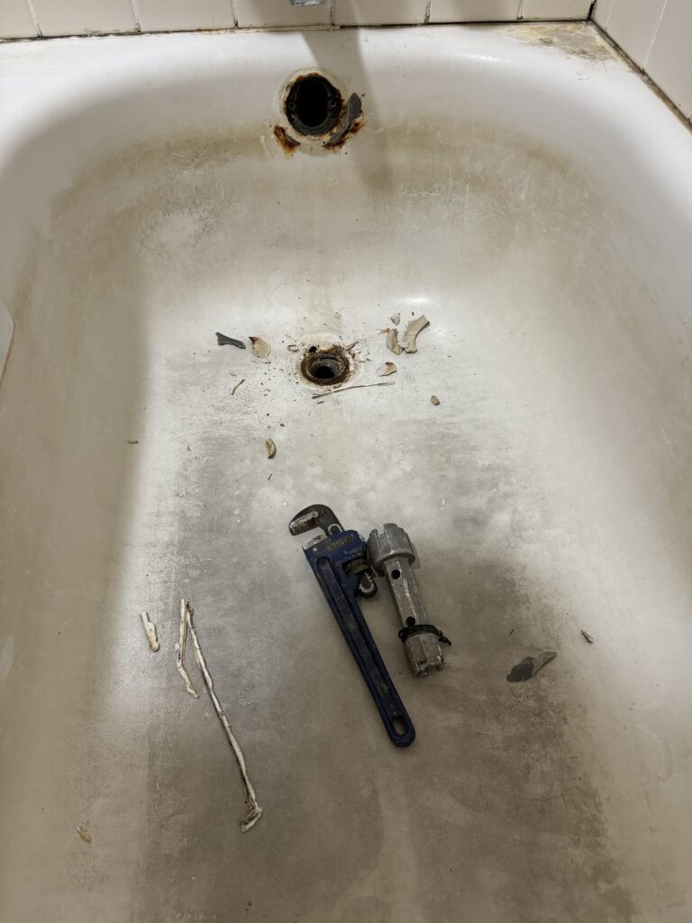 Broken bathtub drain with tools